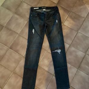 DECREE Black rinse super skinny distress Jean. Cute leather accent on pocket.